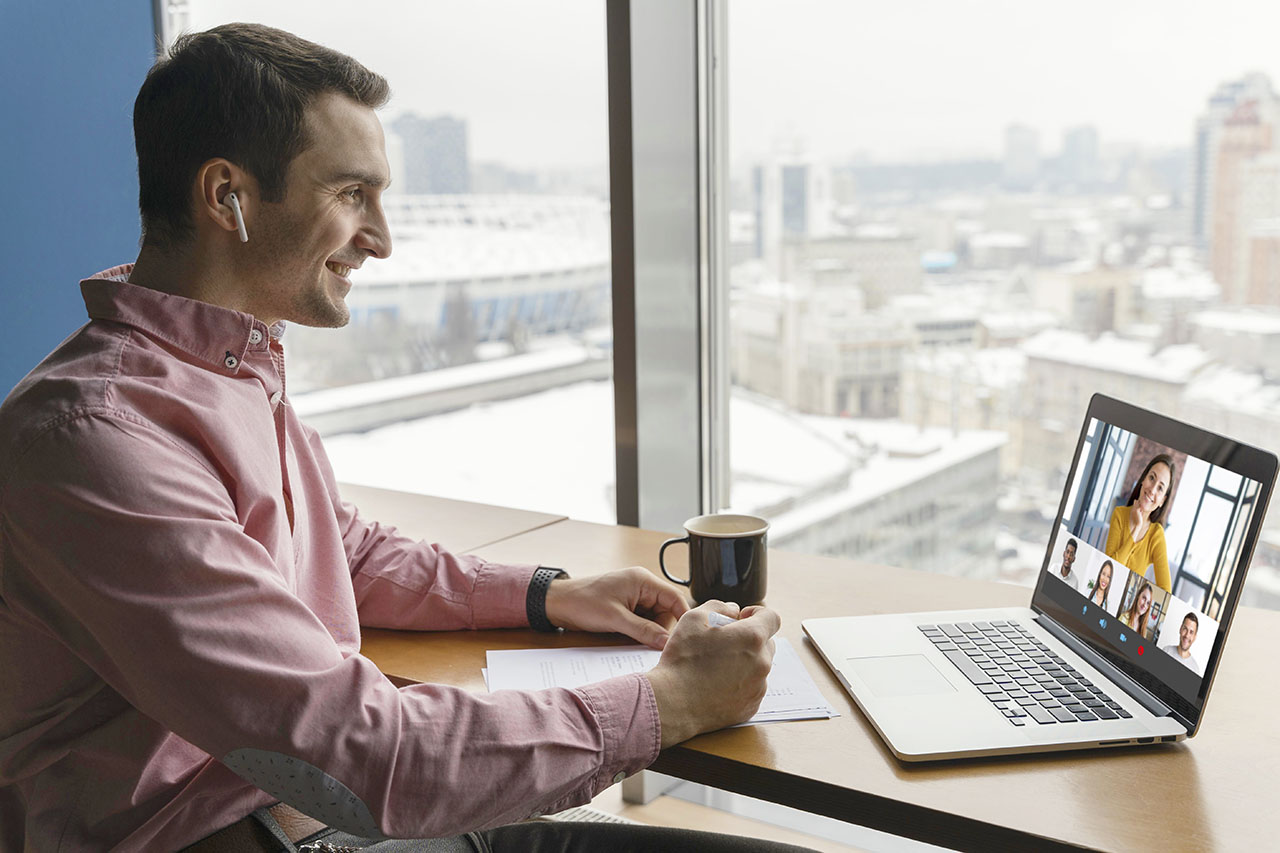 side view man having online video call with coworkers